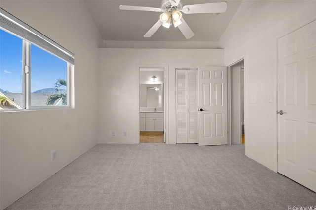 unfurnished bedroom with a closet, ceiling fan, connected bathroom, and carpet floors