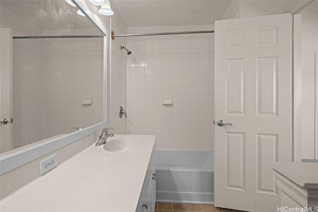 bathroom featuring tiled shower / bath combo, vanity, and tile patterned floors