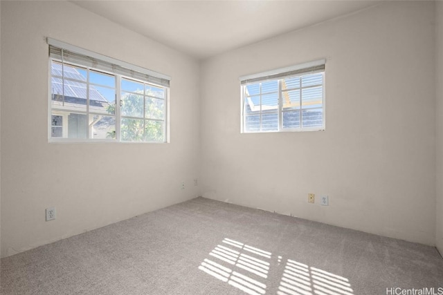 unfurnished room with plenty of natural light and carpet