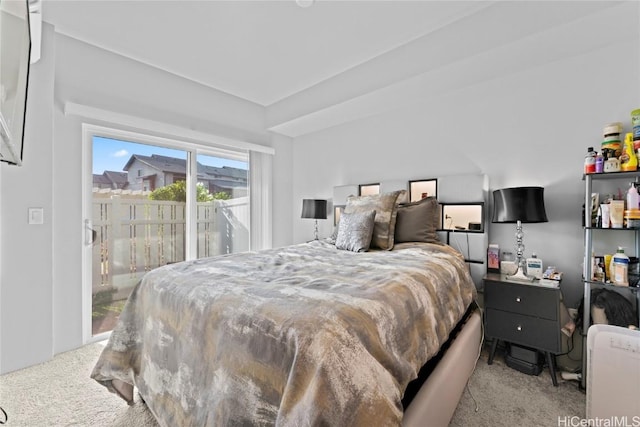 bedroom featuring access to exterior and light carpet