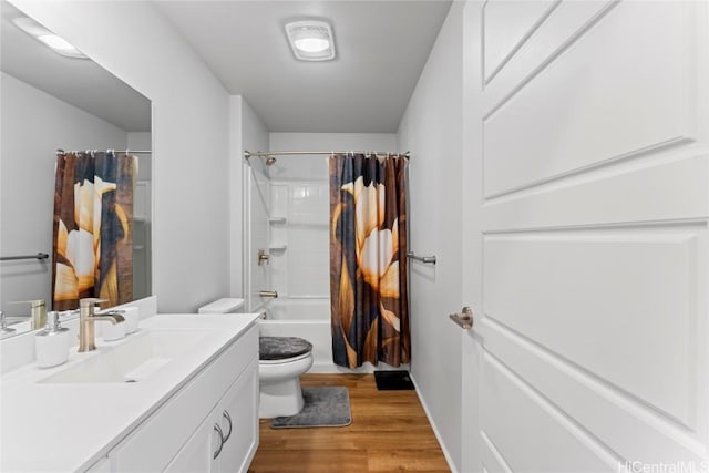 full bathroom with toilet, vanity, hardwood / wood-style flooring, and shower / tub combo with curtain