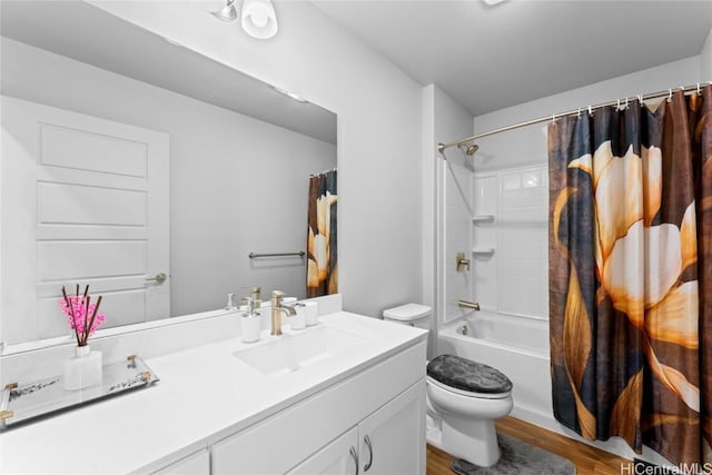 full bathroom featuring hardwood / wood-style floors, shower / bath combo, toilet, and vanity