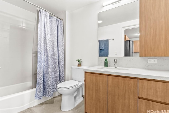 full bathroom featuring tile patterned flooring, vanity, toilet, and shower / bath combo with shower curtain