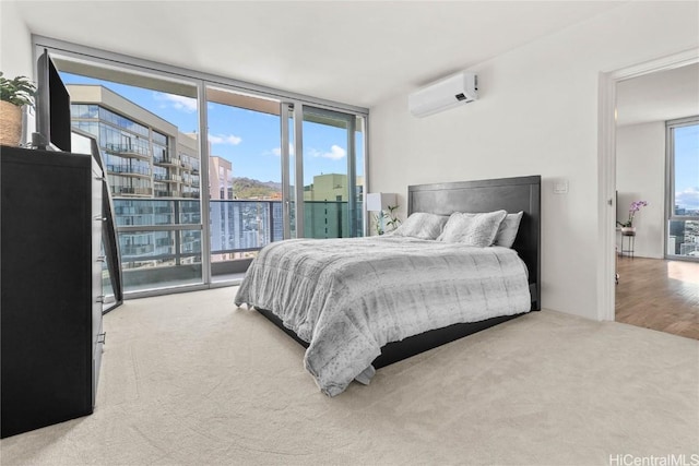 bedroom with a wall mounted air conditioner, access to outside, floor to ceiling windows, and carpet