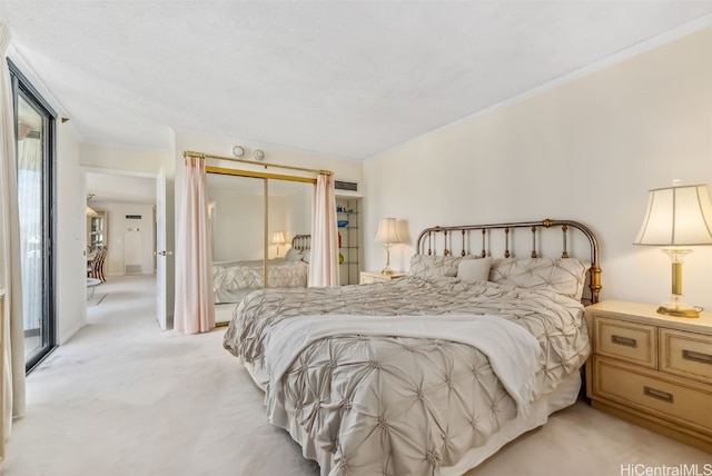 bedroom featuring multiple windows, a closet, and light colored carpet