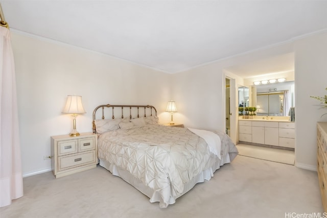 bedroom featuring ornamental molding, ensuite bathroom, light colored carpet, and sink