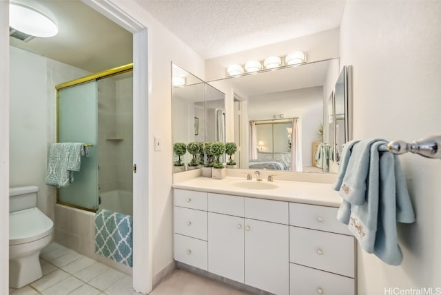 full bathroom with vanity, tile patterned floors, toilet, enclosed tub / shower combo, and a textured ceiling