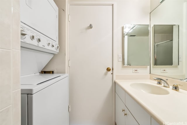 bathroom featuring vanity and stacked washing maching and dryer