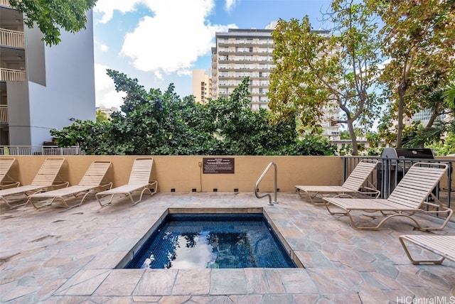 view of pool with a patio area and a community hot tub