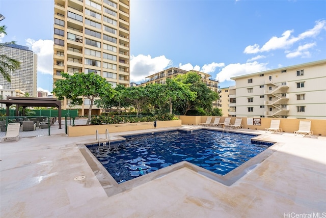 view of swimming pool featuring a patio area