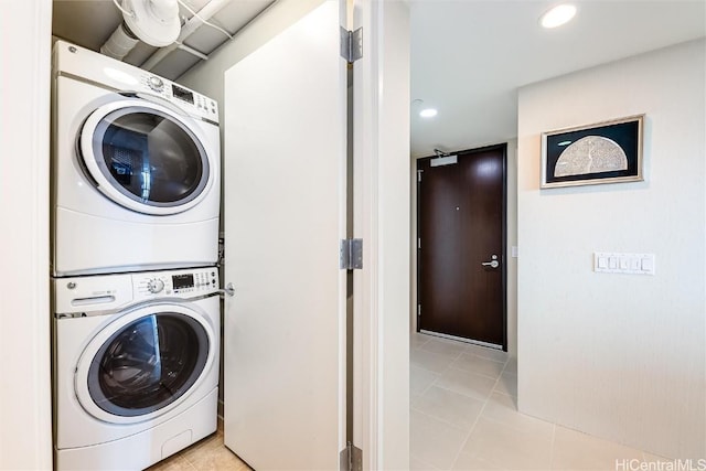 washroom featuring stacked washer / drying machine and light tile patterned floors