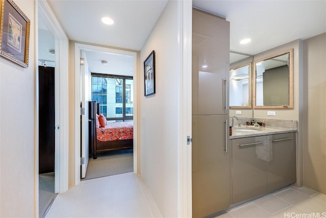 hall with light tile patterned floors and sink