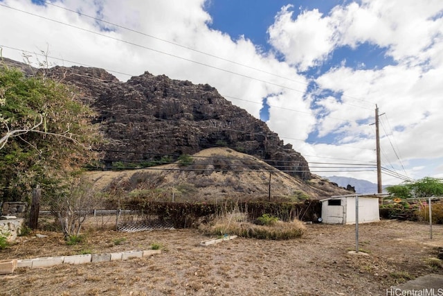 view of home's exterior featuring a mountain view and an outbuilding