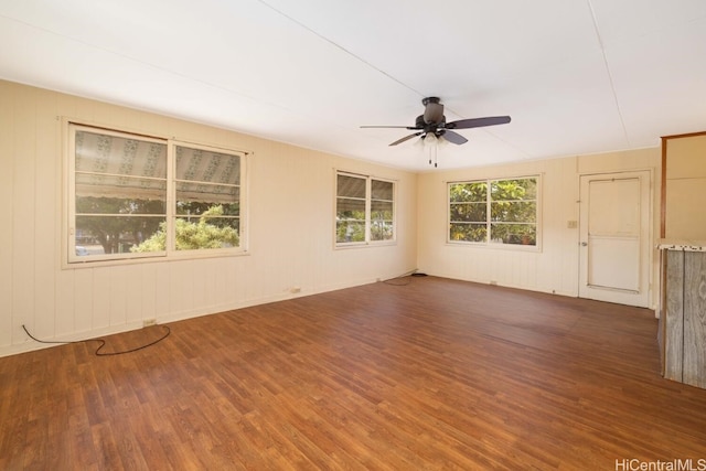 unfurnished room featuring ceiling fan and dark wood-type flooring