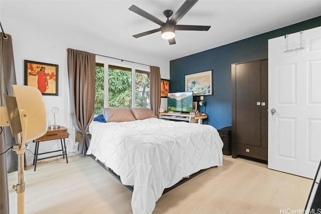 bedroom with light hardwood / wood-style floors and ceiling fan