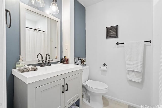 bathroom featuring vanity and toilet