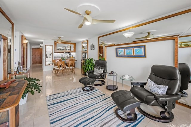 living area with ceiling fan and light tile patterned flooring