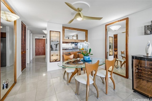 tiled dining room with wine cooler and ceiling fan