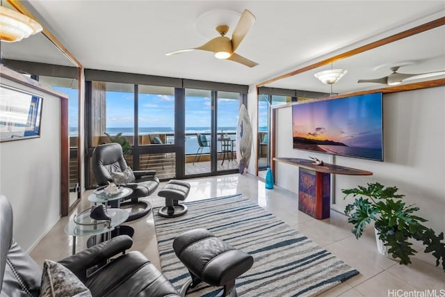 tiled living room featuring a wall of windows and ceiling fan