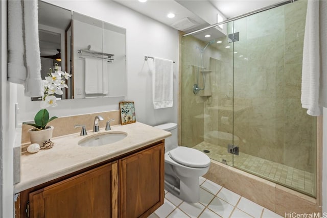 bathroom with tile patterned floors, toilet, an enclosed shower, and vanity