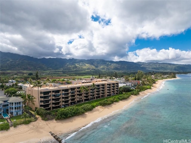 aerial view with a water and mountain view and a view of the beach