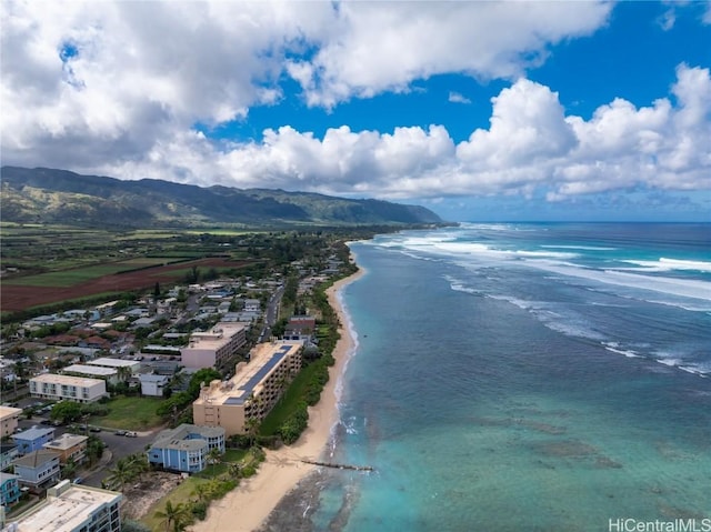 drone / aerial view featuring a view of the beach and a water and mountain view