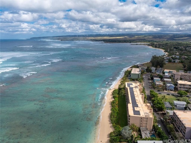 birds eye view of property featuring a water view and a beach view