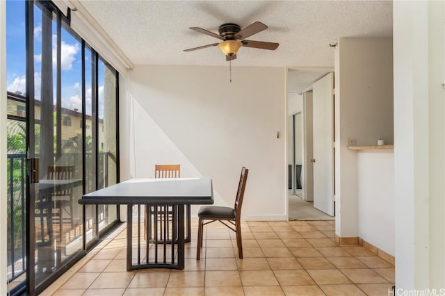 dining area featuring a textured ceiling, ceiling fan, and light tile patterned floors