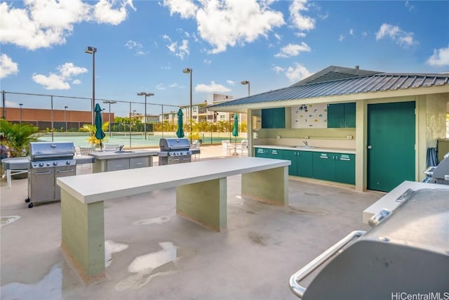 view of patio / terrace featuring exterior kitchen, grilling area, and sink