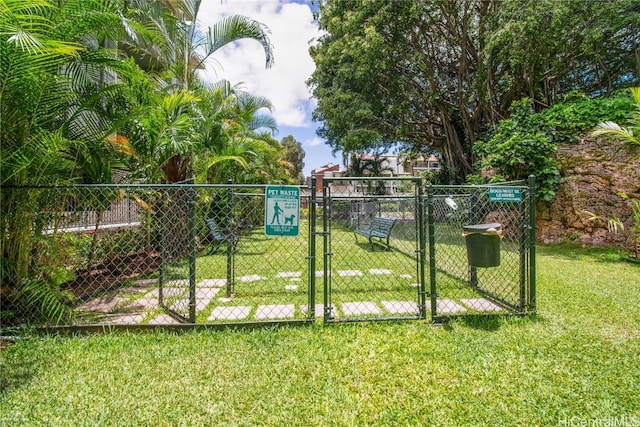 view of gate featuring a yard