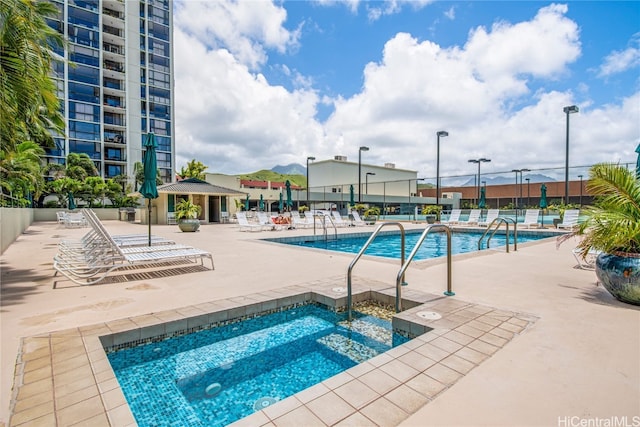 view of swimming pool with a community hot tub, a gazebo, and a patio area