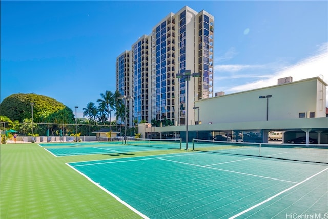 view of tennis court with basketball hoop