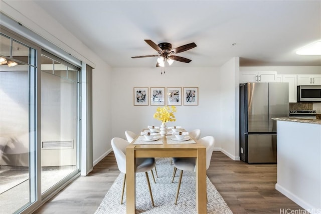 dining room featuring light hardwood / wood-style floors and ceiling fan