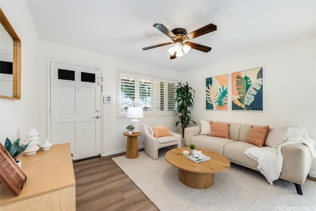 living room with wood-type flooring and ceiling fan