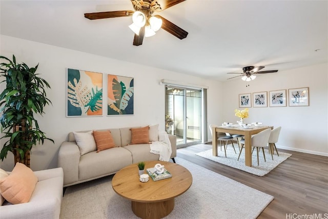 living room with hardwood / wood-style floors and ceiling fan