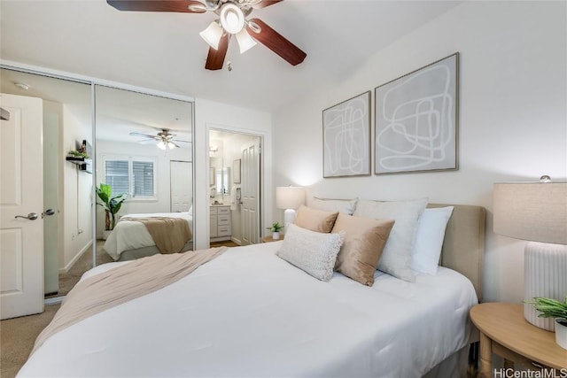 carpeted bedroom with ceiling fan, ensuite bath, and a closet