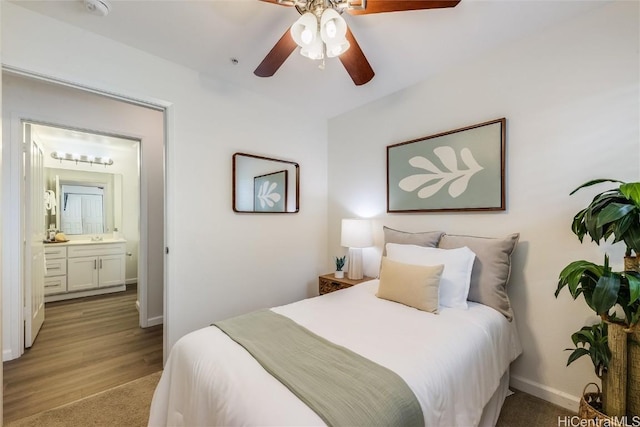 bedroom with ceiling fan, connected bathroom, and light hardwood / wood-style floors