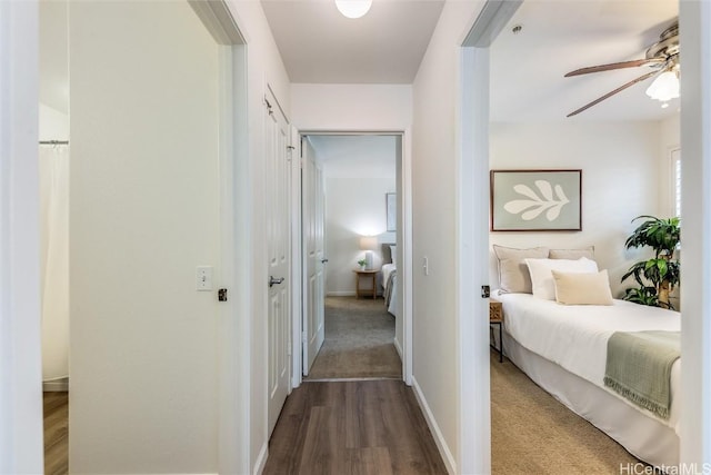 corridor with hardwood / wood-style floors