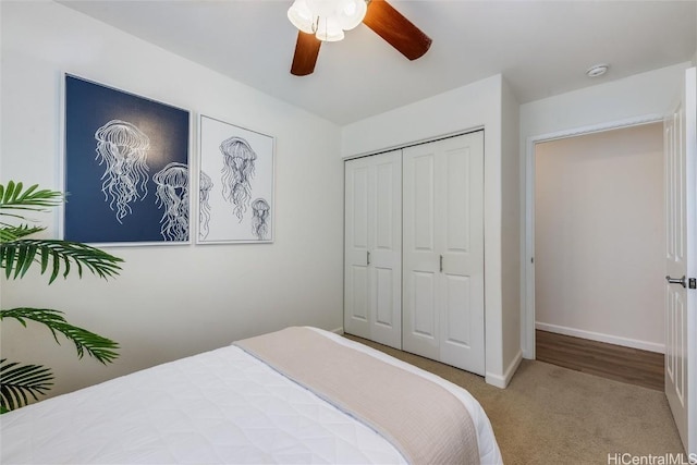 carpeted bedroom with ceiling fan and a closet