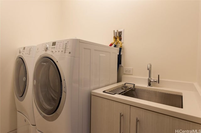 washroom with washer and clothes dryer and sink