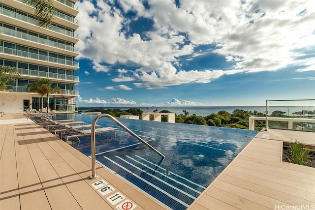 view of pool with a water view