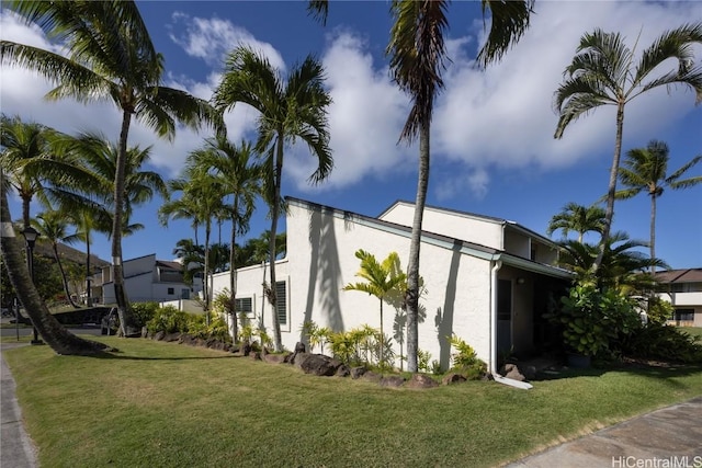 view of home's exterior with a yard