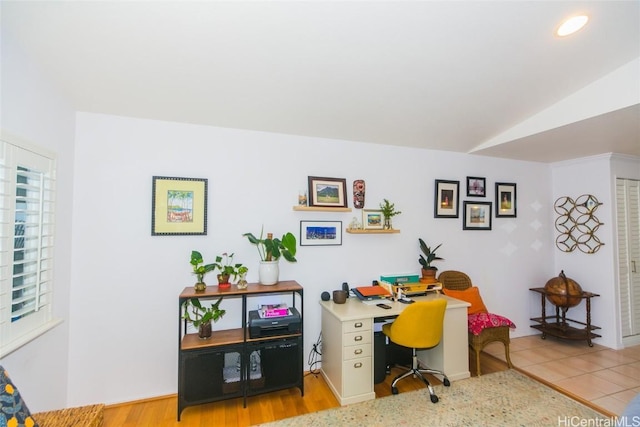 office space with light hardwood / wood-style floors and lofted ceiling