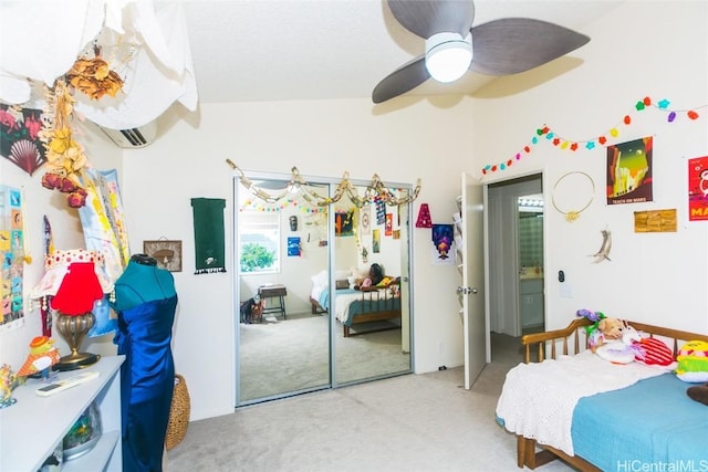 bedroom featuring ceiling fan, a closet, light colored carpet, and vaulted ceiling