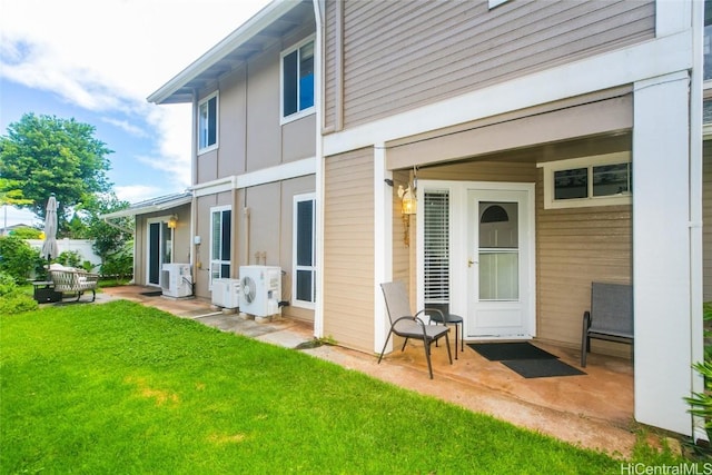 rear view of property with a yard and ac unit