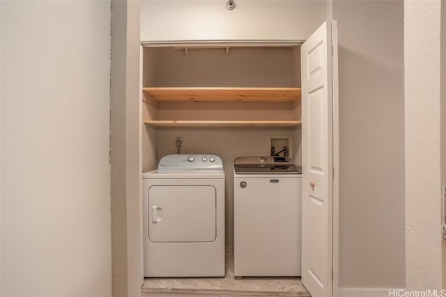 laundry room featuring washing machine and clothes dryer