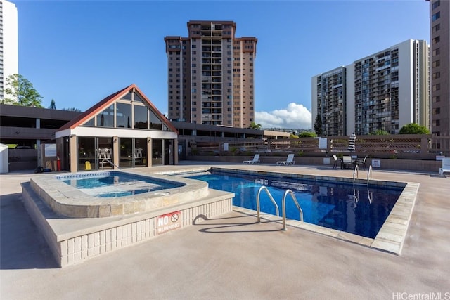 view of pool featuring a community hot tub and a patio