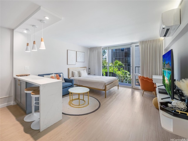 364 Seaside Ave Unit 403, Honolulu, HI 96815 - bedroom with expansive windows, access to exterior, light wood-style flooring, and a wall mounted AC