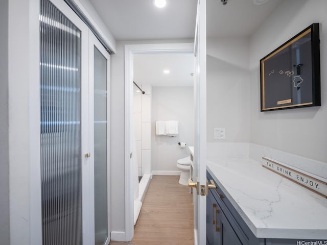 364 Seaside Ave Unit 403, Honolulu, HI 96815 - bathroom with wood finished floors, vanity, a stall shower, and recessed lighting