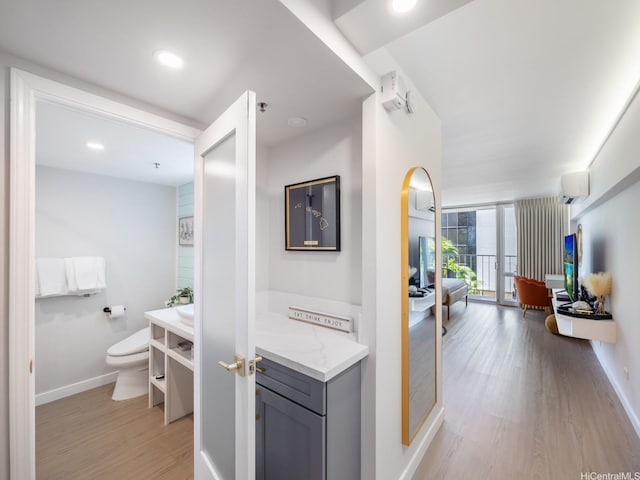 364 Seaside Ave Unit 403, Honolulu, HI 96815 - corridor featuring light wood finished floors, baseboards, and a wall unit AC